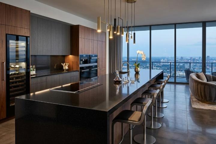 Luxury kitchen workspace showcasing a large absolute black granite island