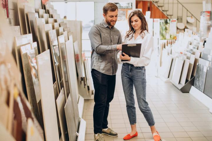 Customers comparing tile samples in showroom for budget planning