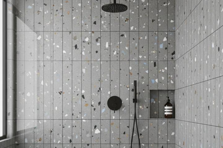 Gray terrazzo subway tiles in a modern walk-in shower